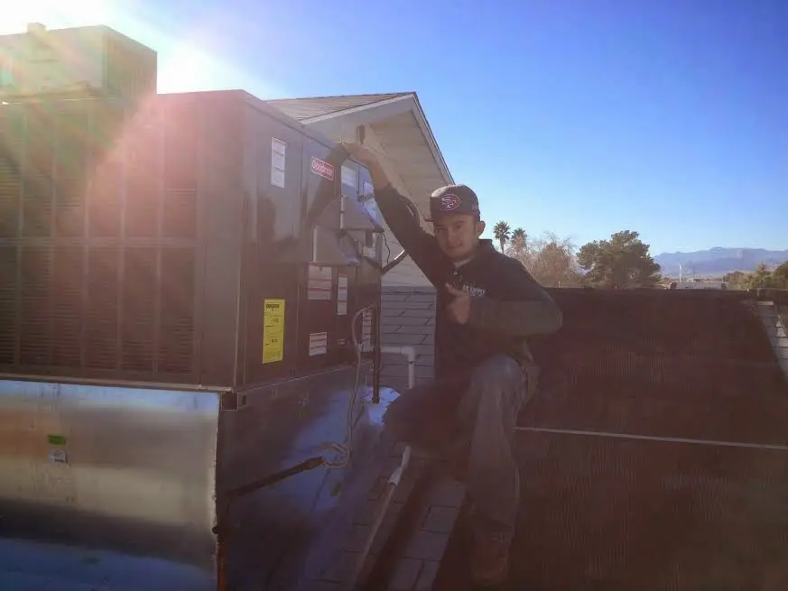 HVAC technician performing HVAC Inspection on a rooftop unit in Atlanta